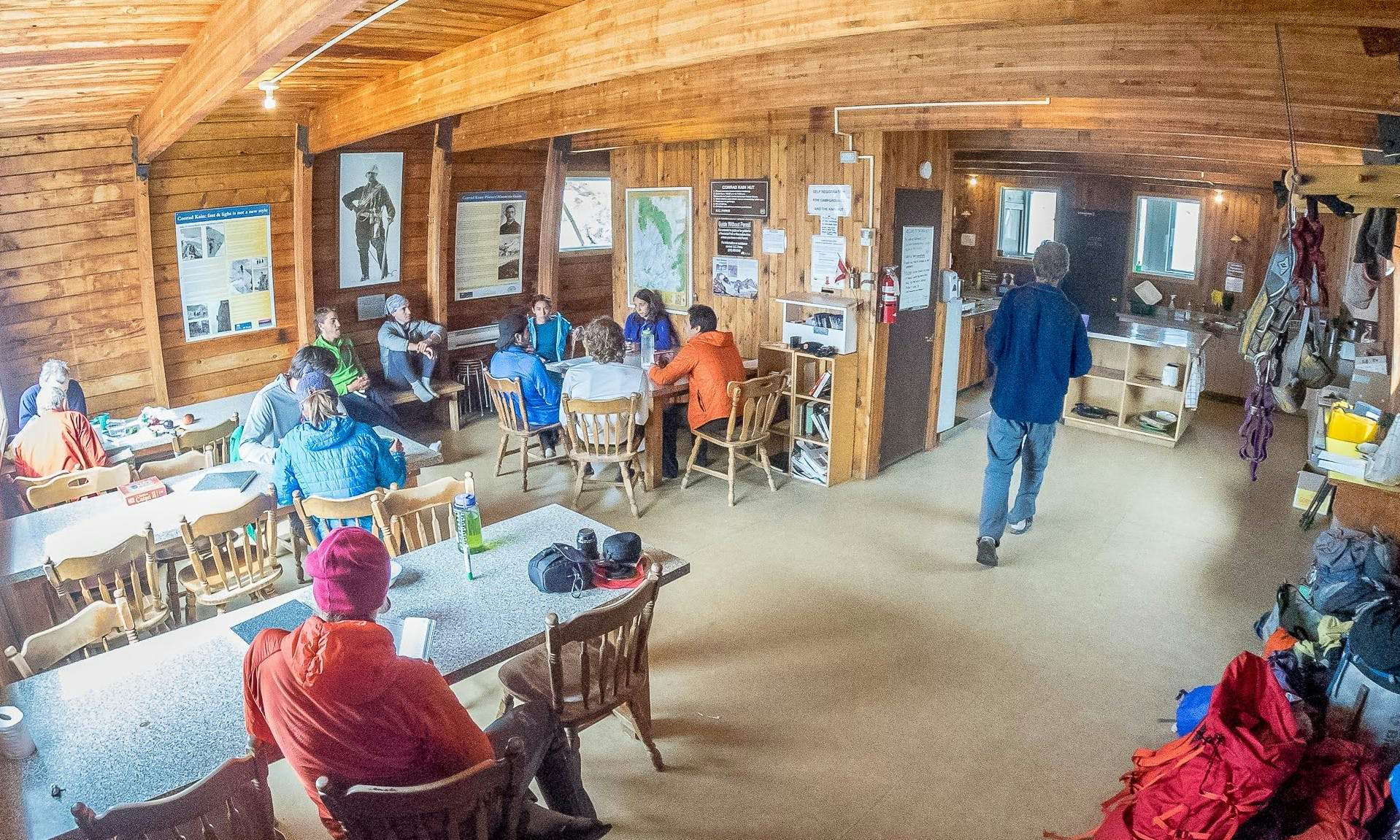 People in a cabin sitting at tables and eating