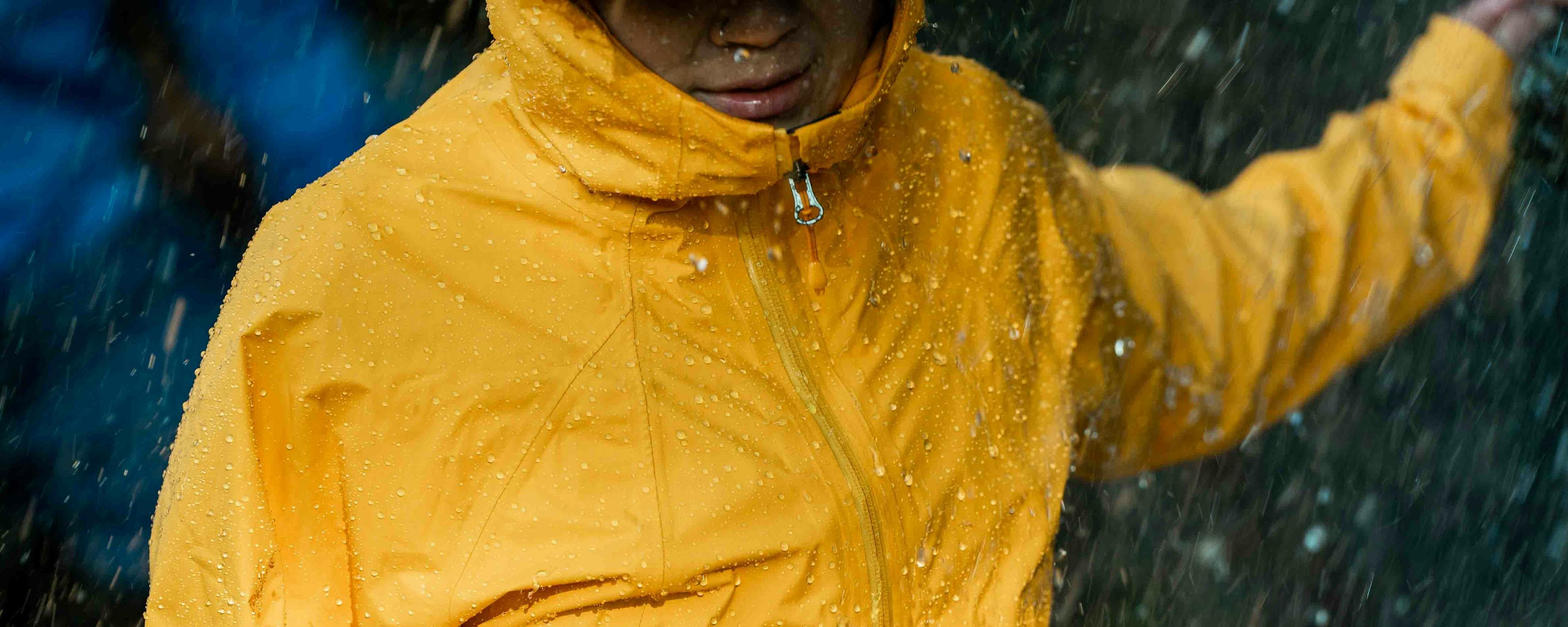 Hiker wearing a yellow rain jacket outside
