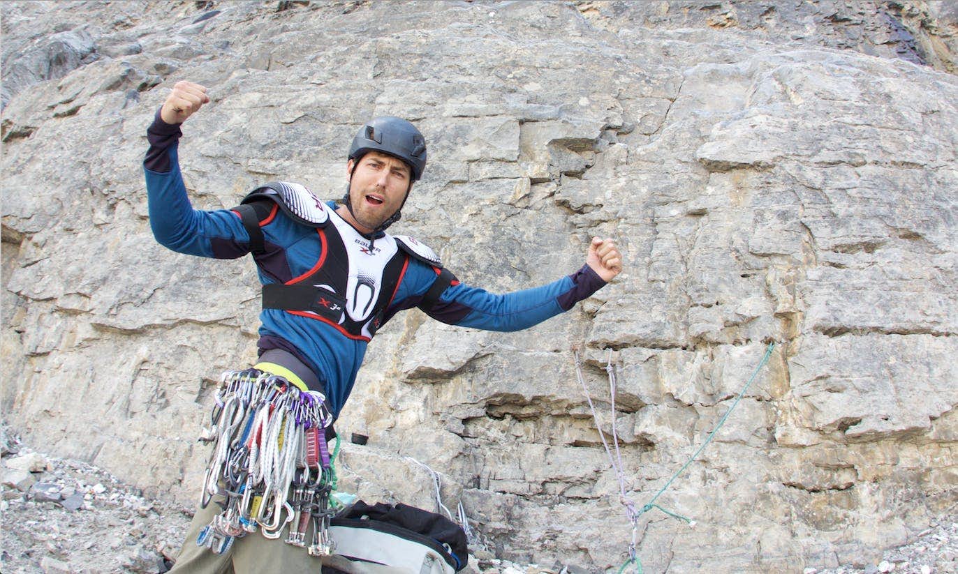 Rock climber wearing body armour and climbing gear