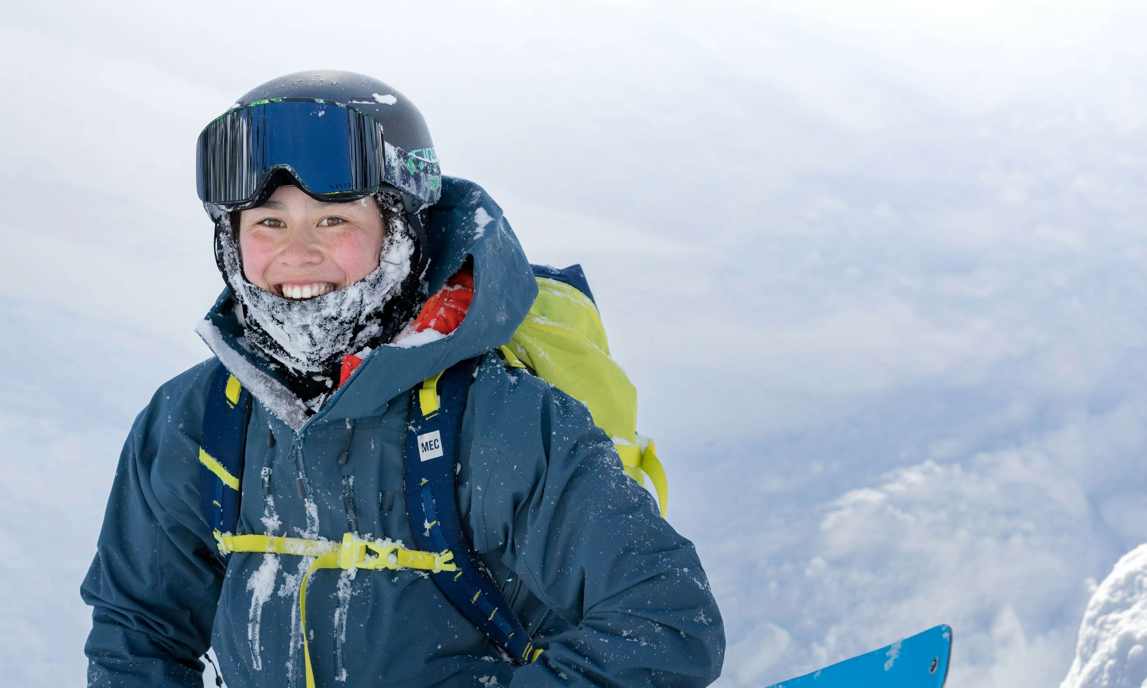 MEC Ambassador Yuki Tsubota smiling with ski goggles, surrounded by snow