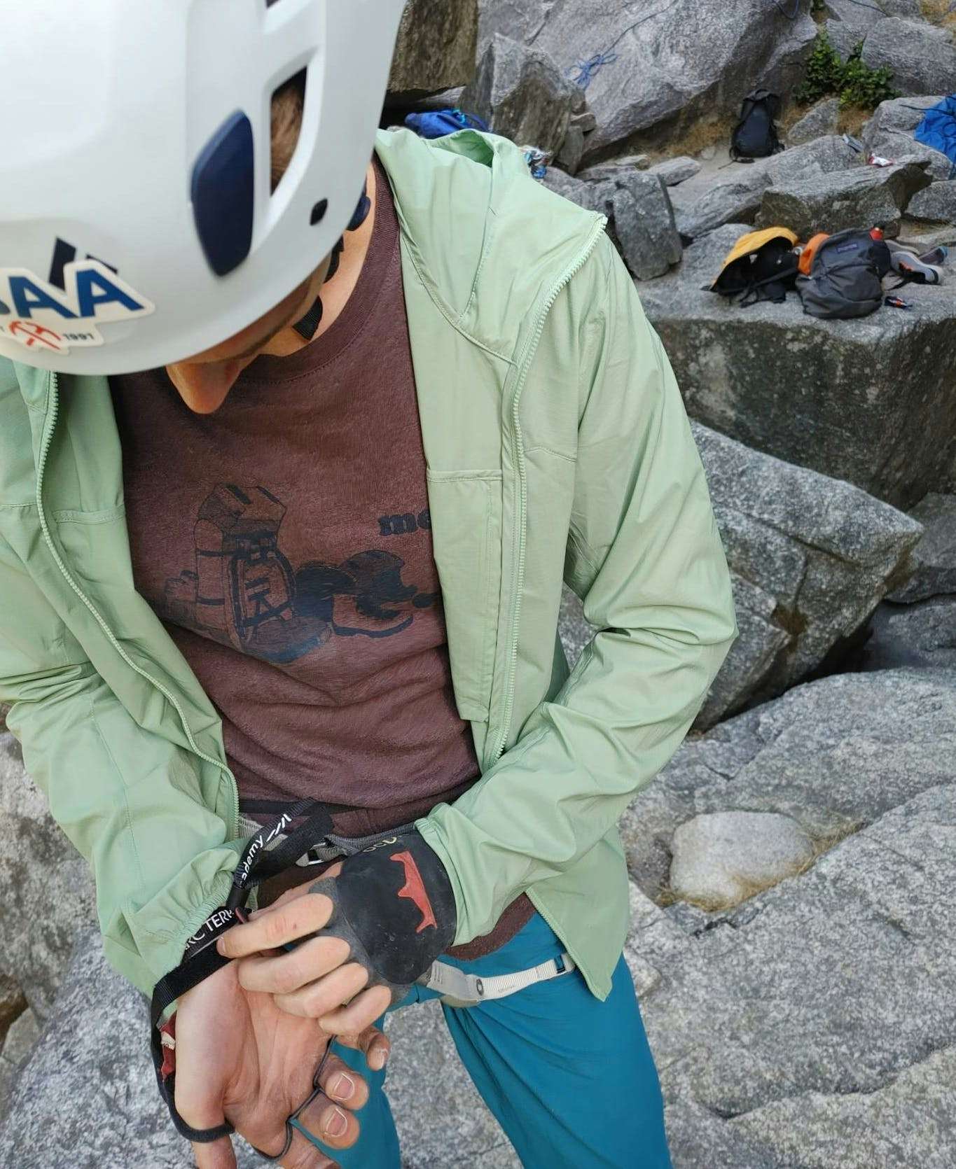 Climber wearing crack climbing gloves, adjusting how they fit 