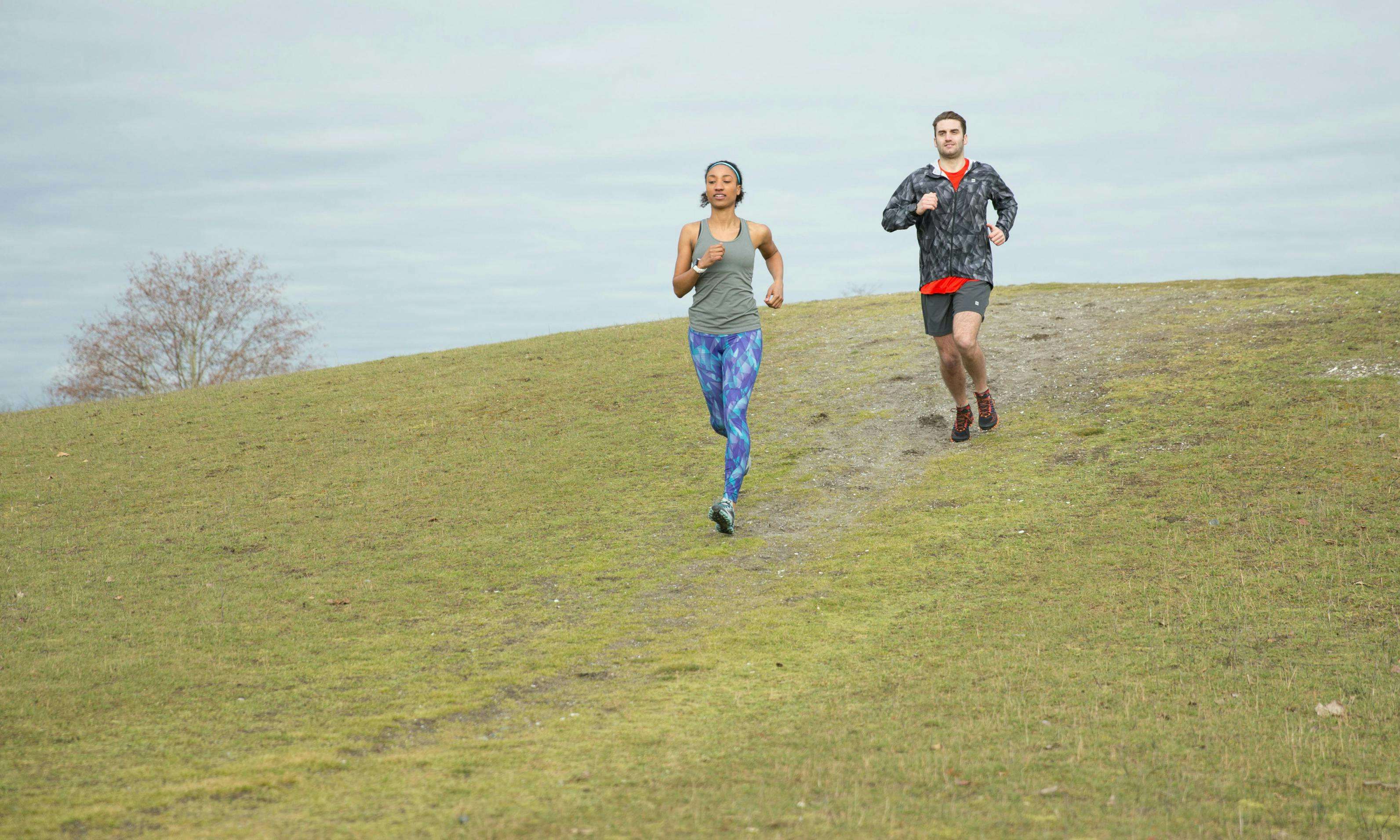 Two runners running downhill