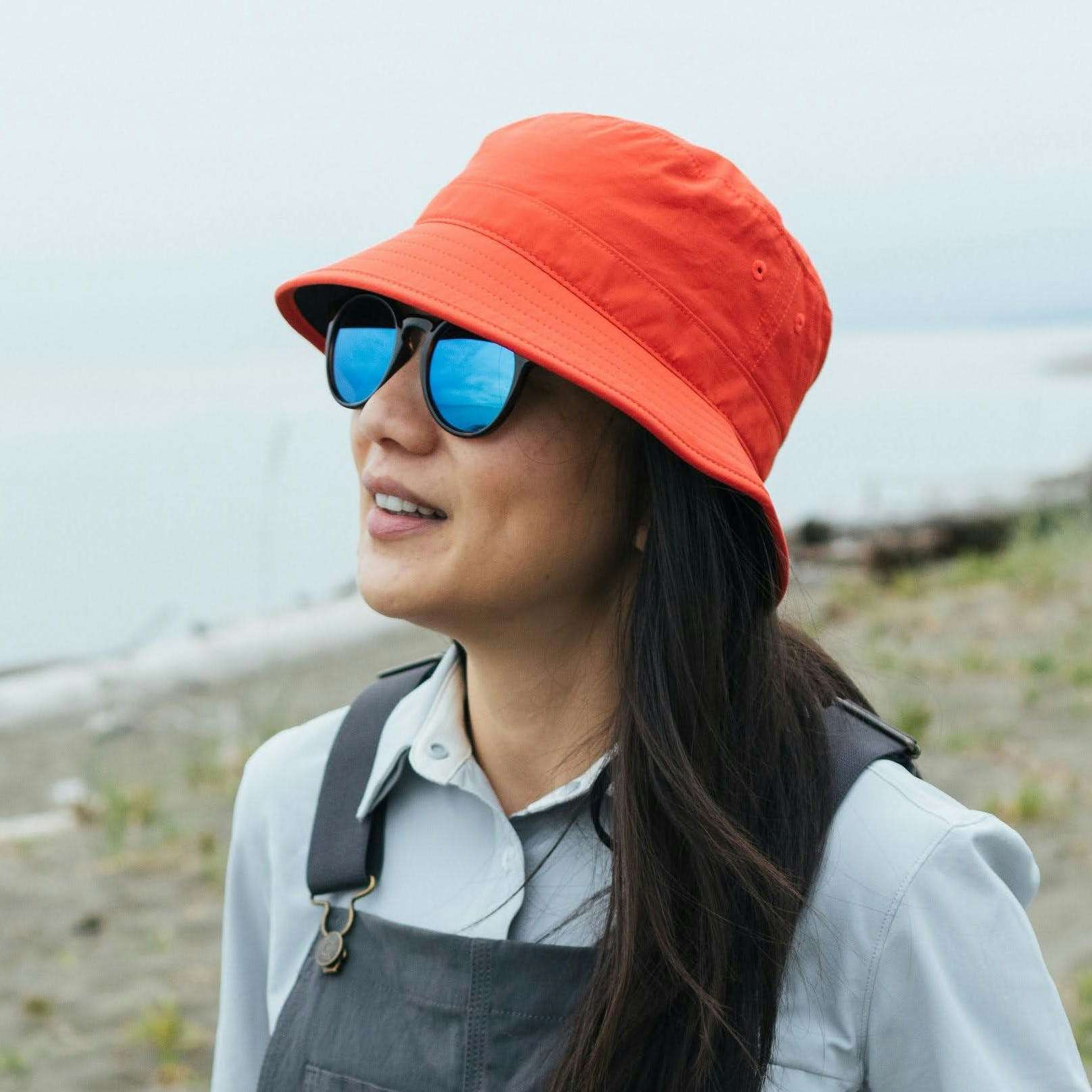 Person wearing sunglasses and a red bucket hat