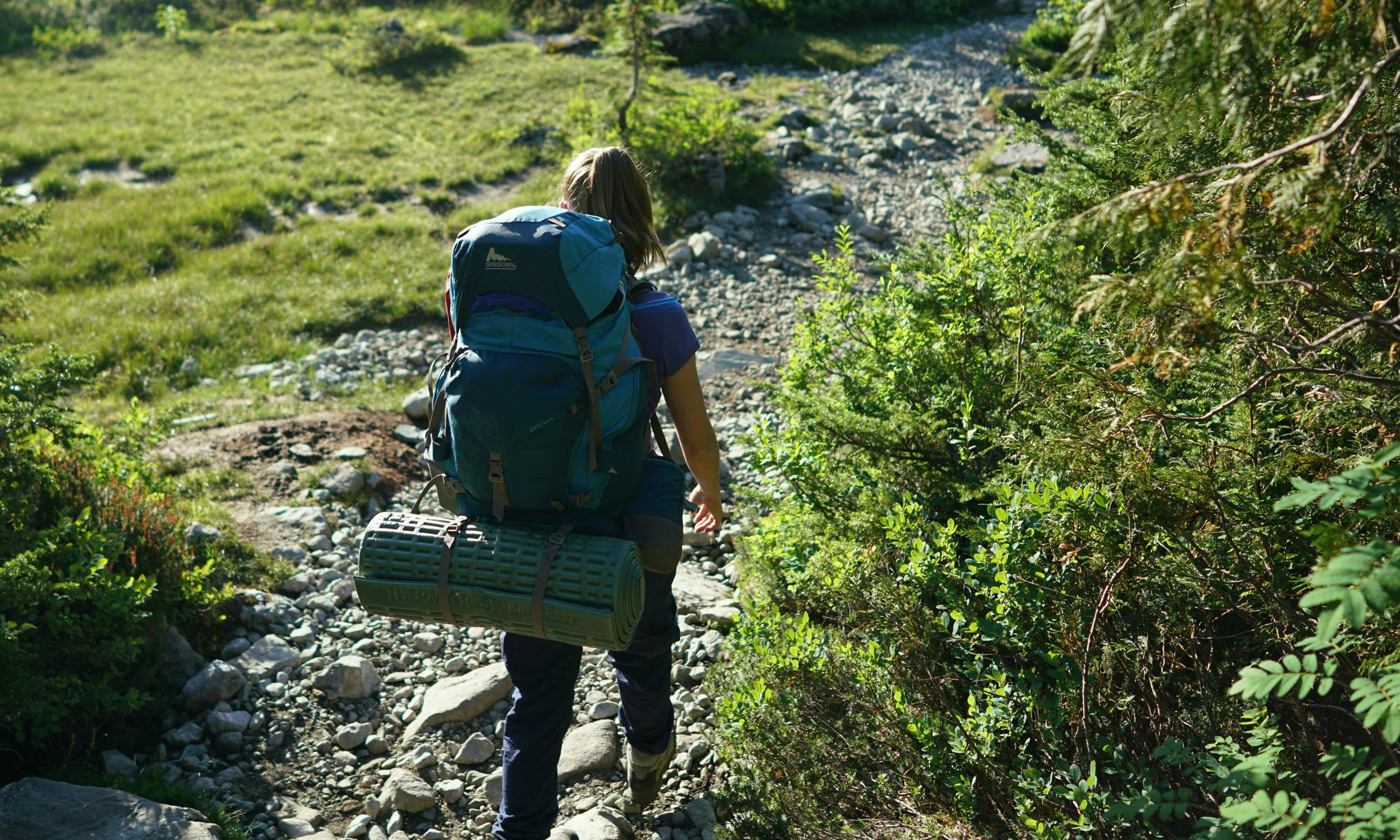 Backpacker carrying a closed-cell foam sleeping pad