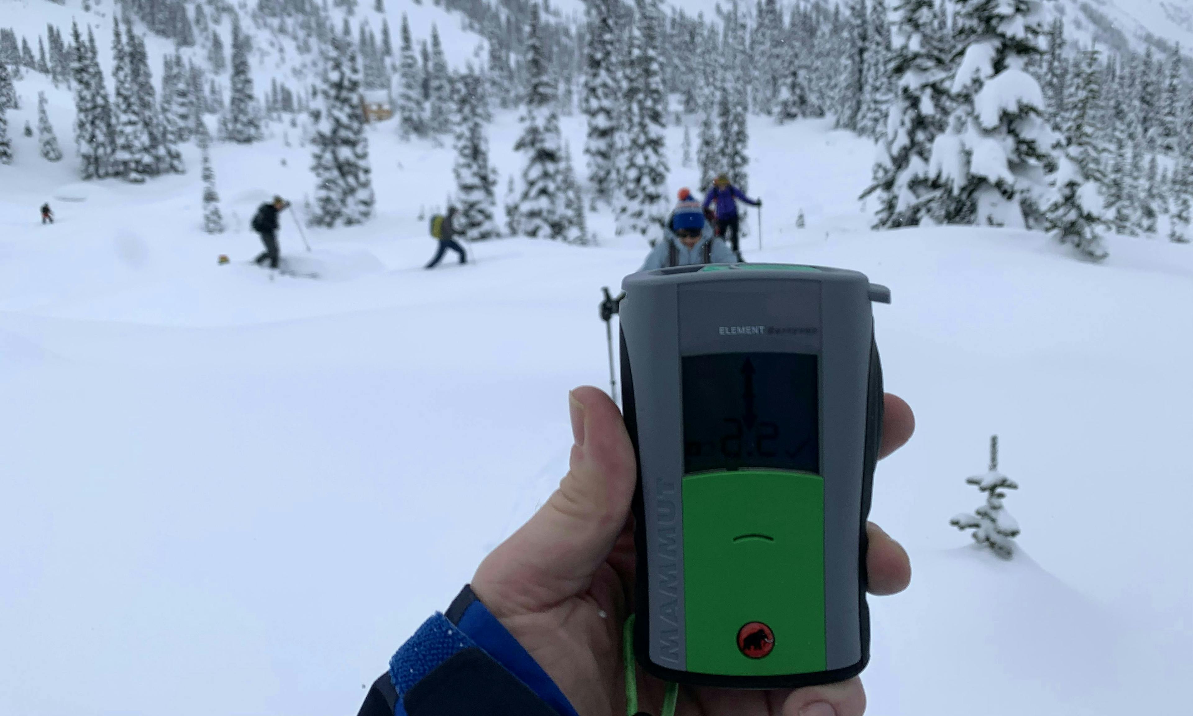 Skier holding a beacon the backcountry