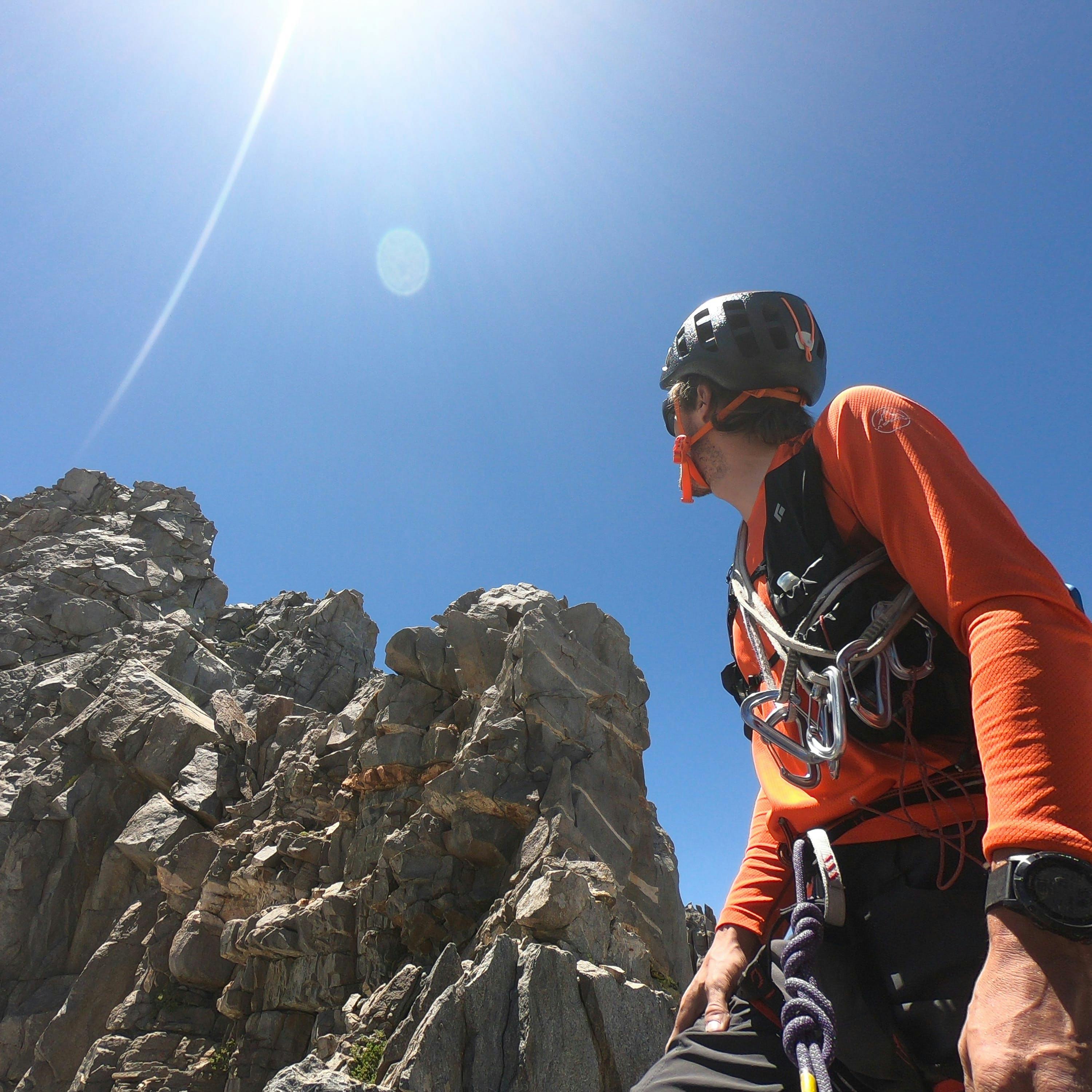 Nick Elson looking up at a rocky summit