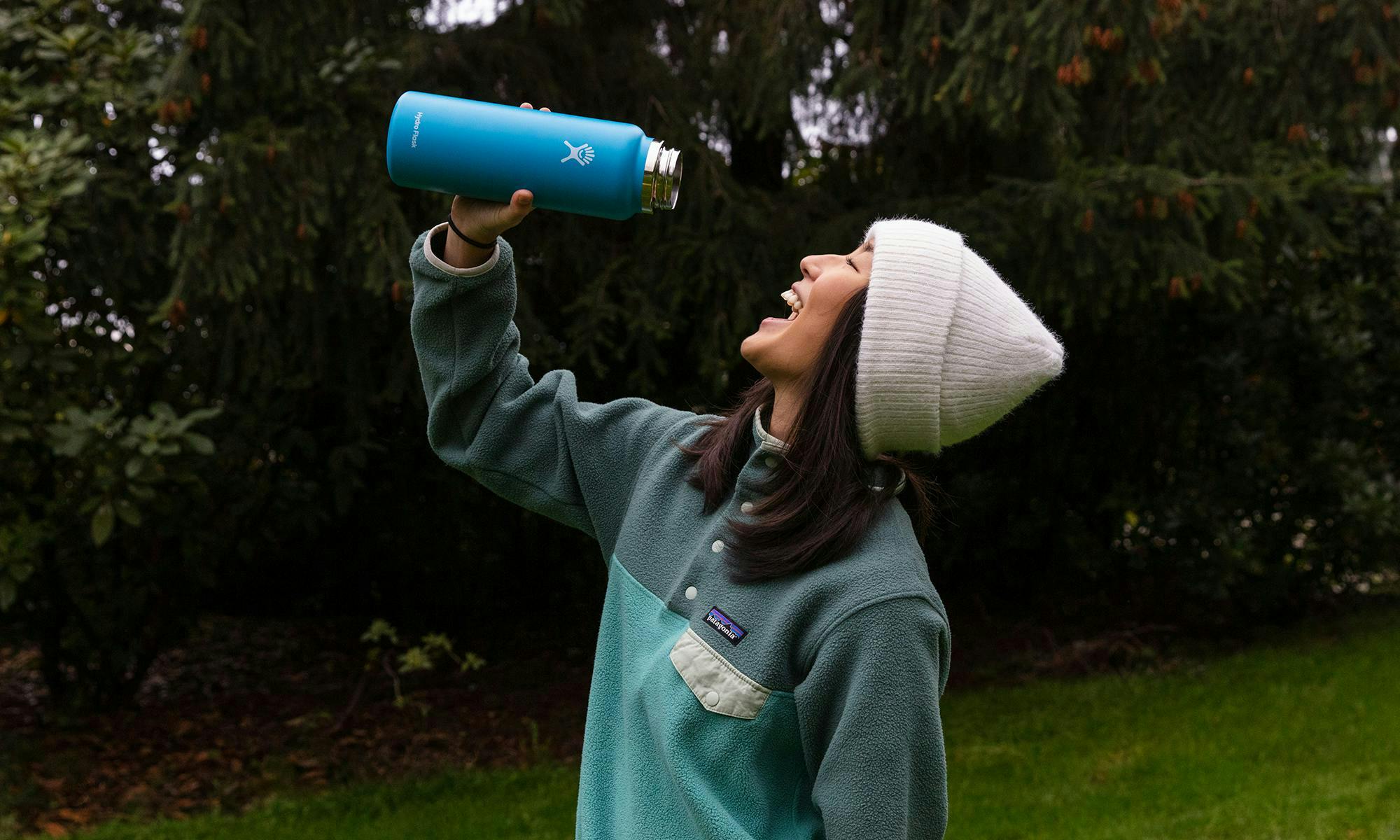Cheena drinking out of a Hydroflask bottle