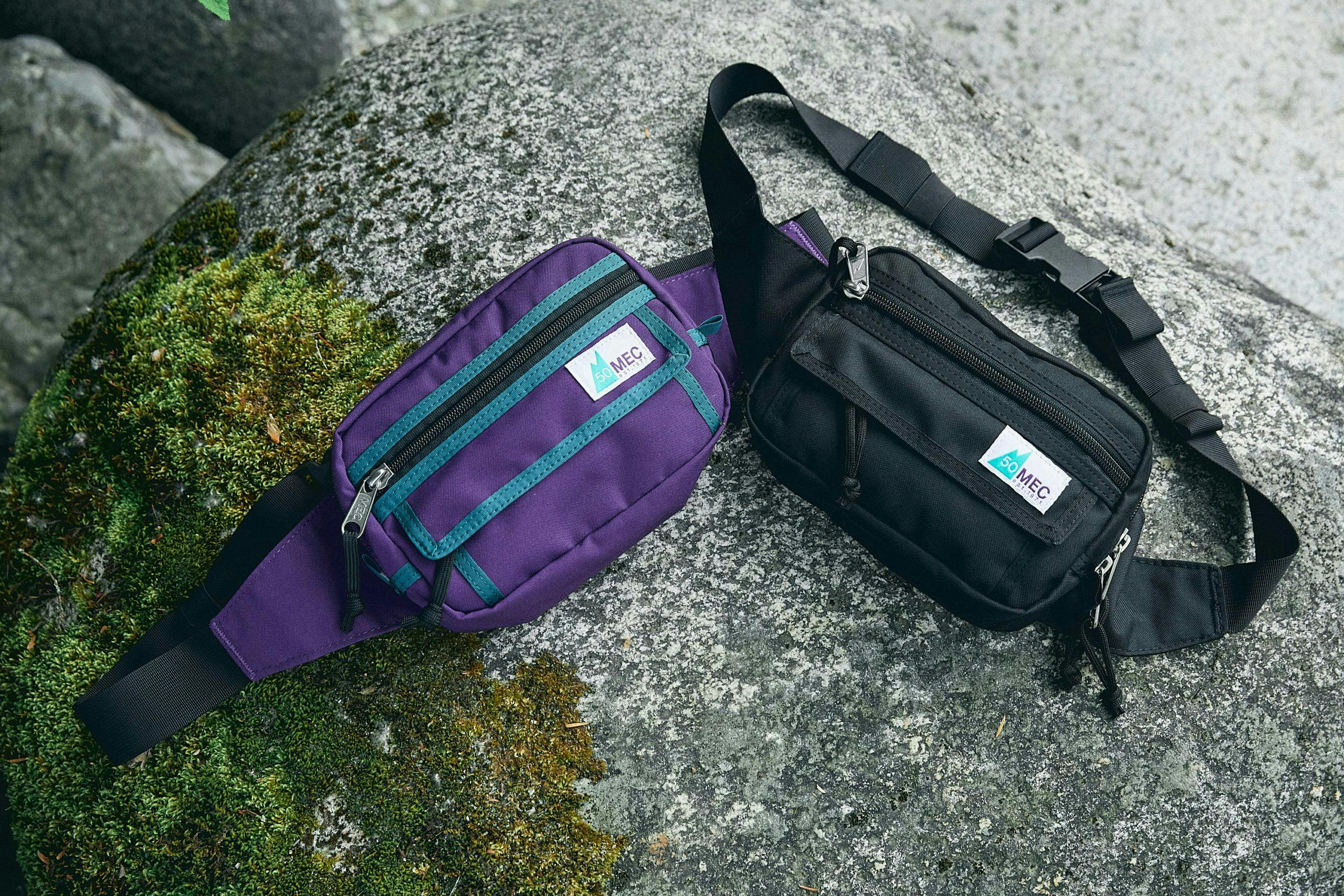 Two fanny packs sitting on a rock