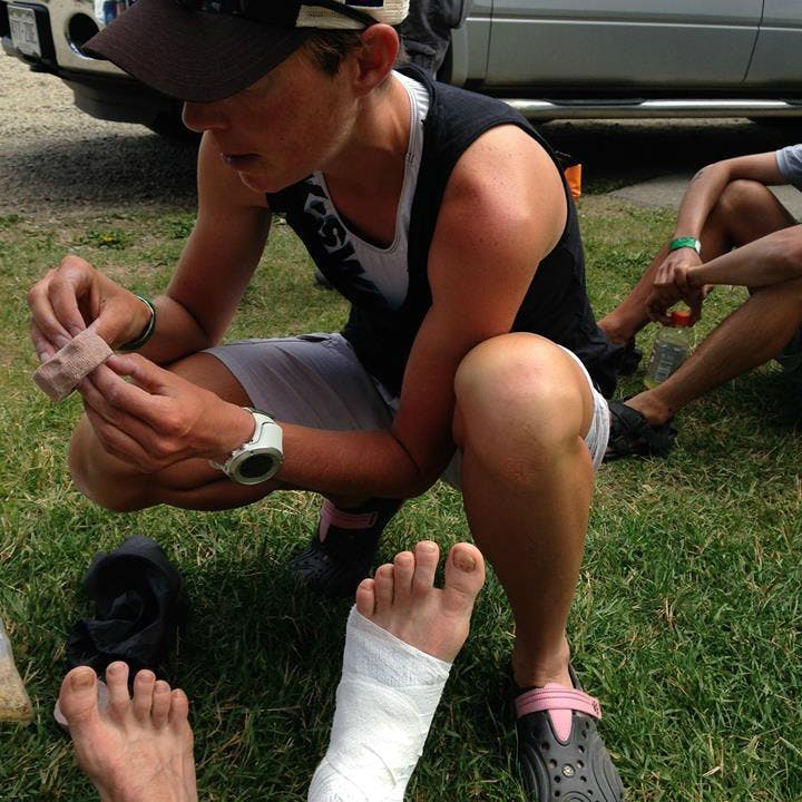 MEC Ambassador Annie Jean treating another runner's foot injury