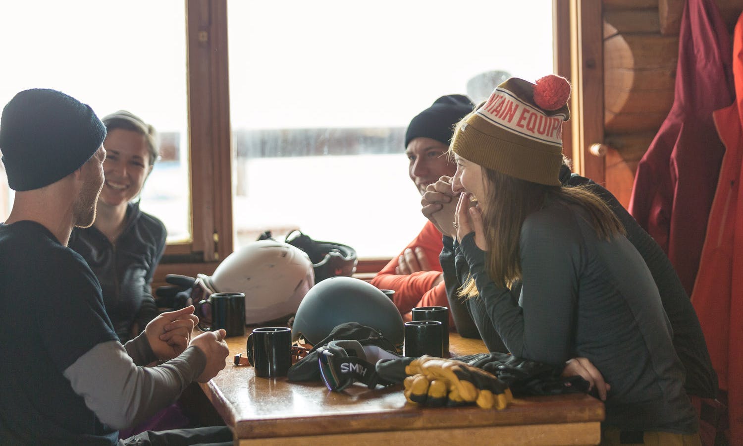 Group of skiers in a lodge drinking coffee