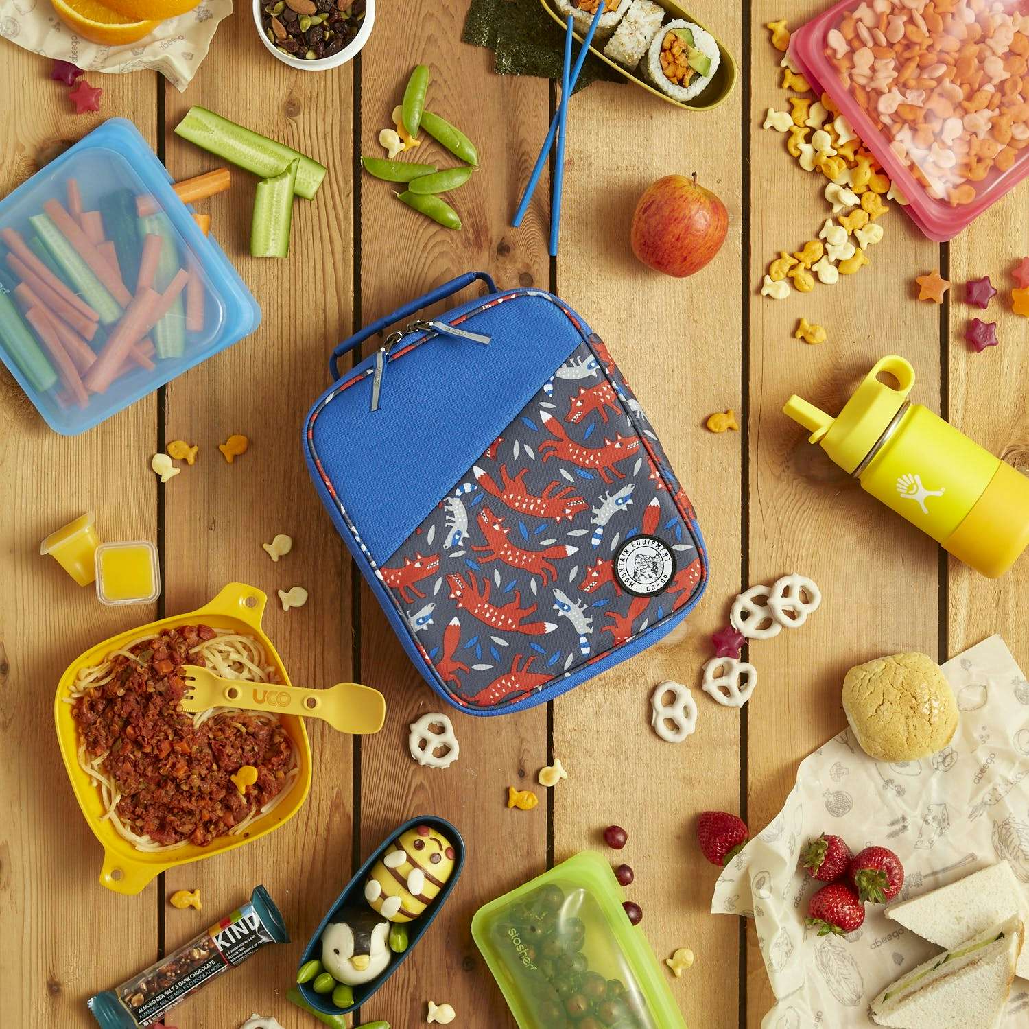 Kids lunch kit, surrounded by a random assortment of snacks