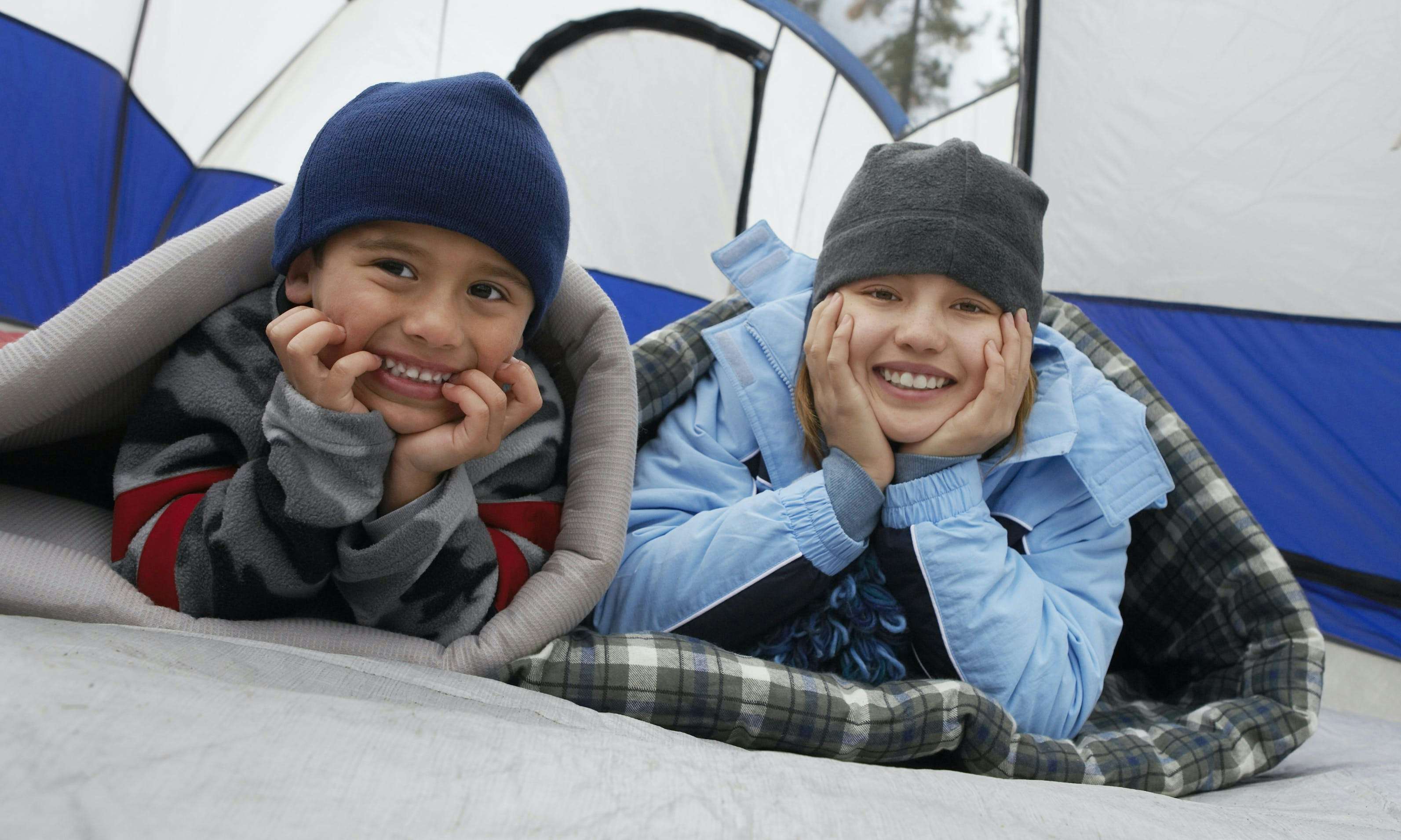 Kids bundled up in a tent