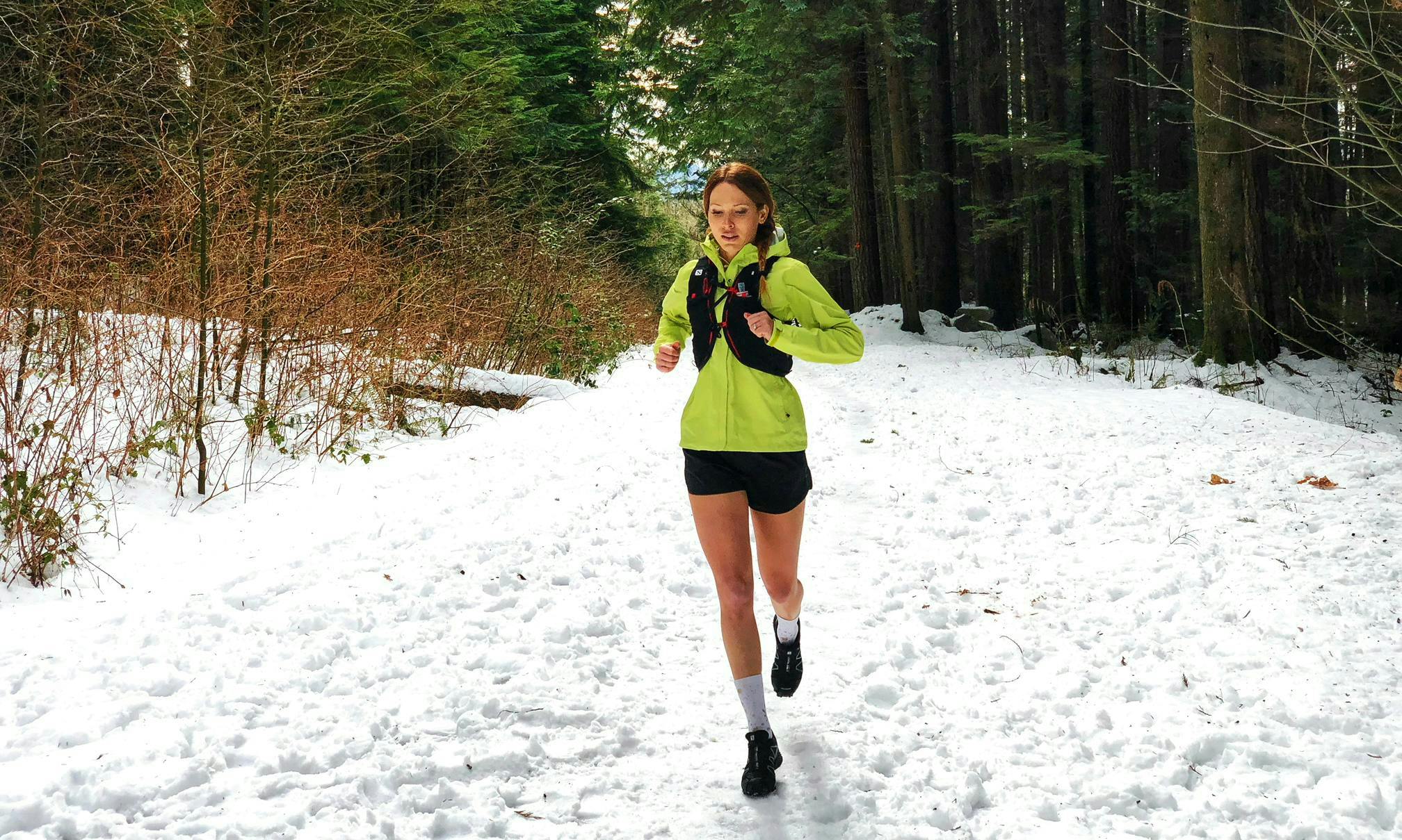 Mel Offner trail running on a snowy trail