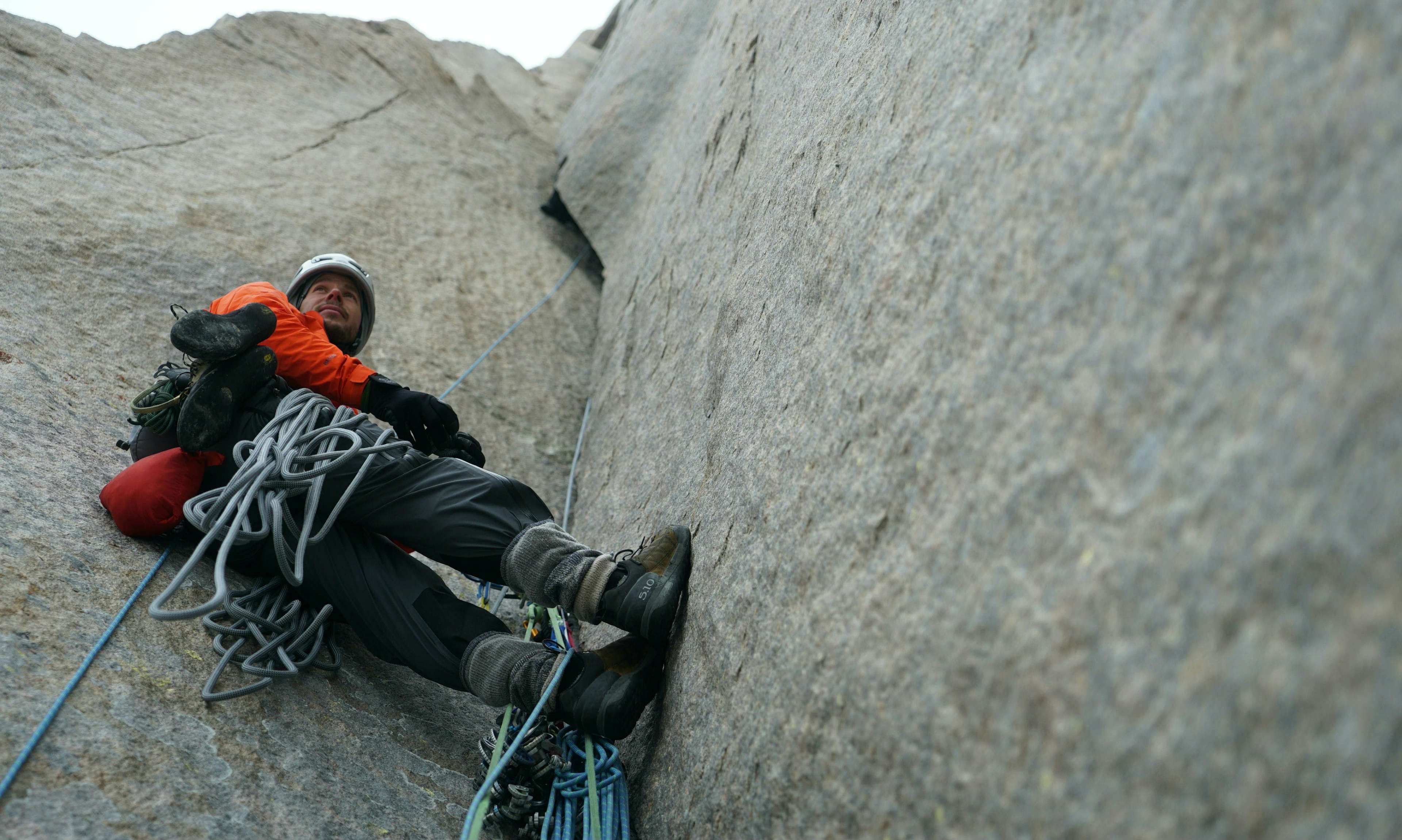 Climber Josh Lavigne holds the rope on Baffin Island