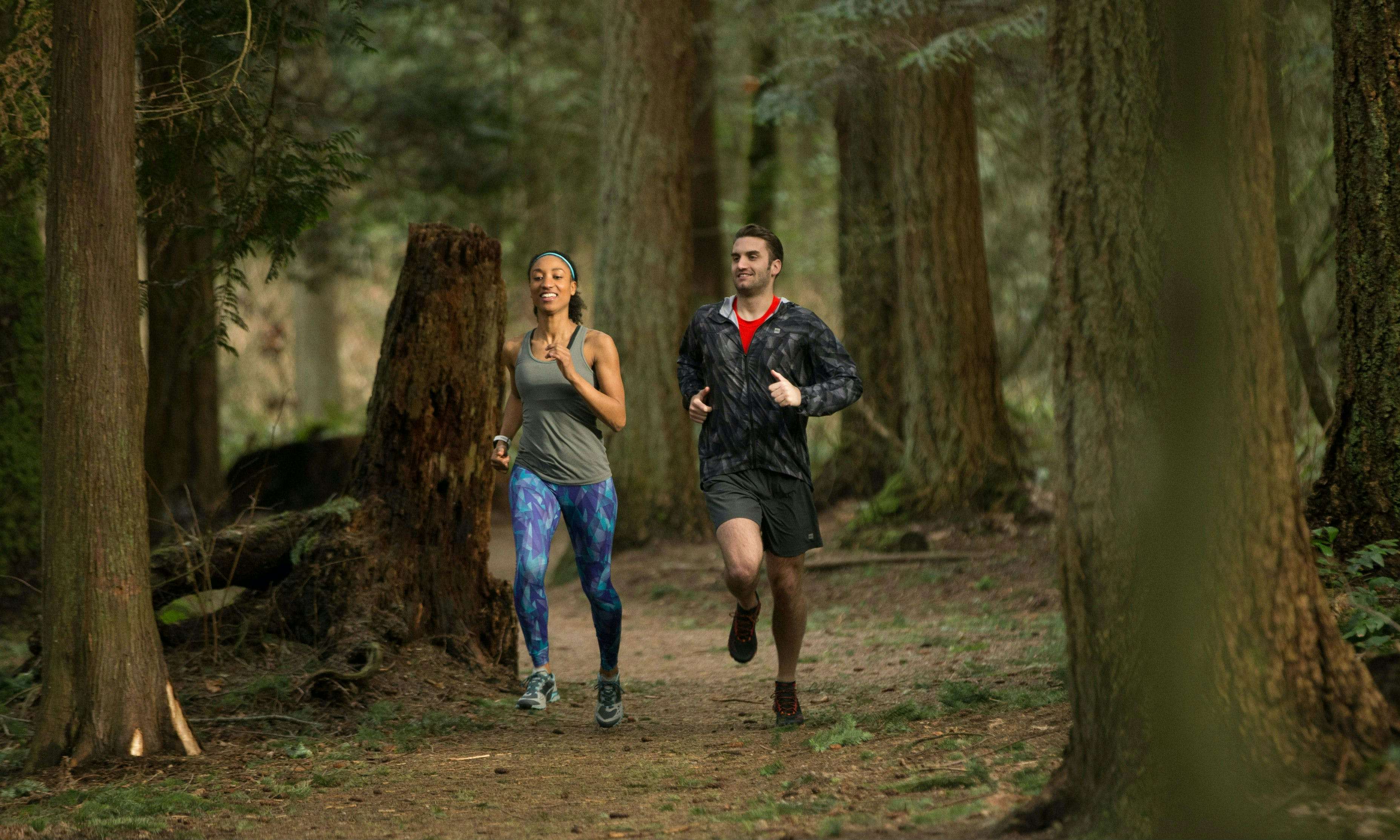 Two trail runners in the forest