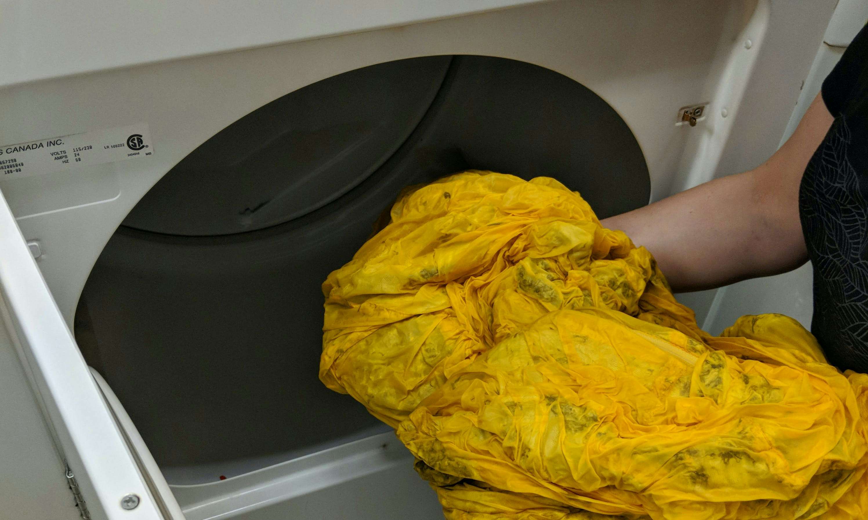 Placing a wet down sleeping bag in the dryer