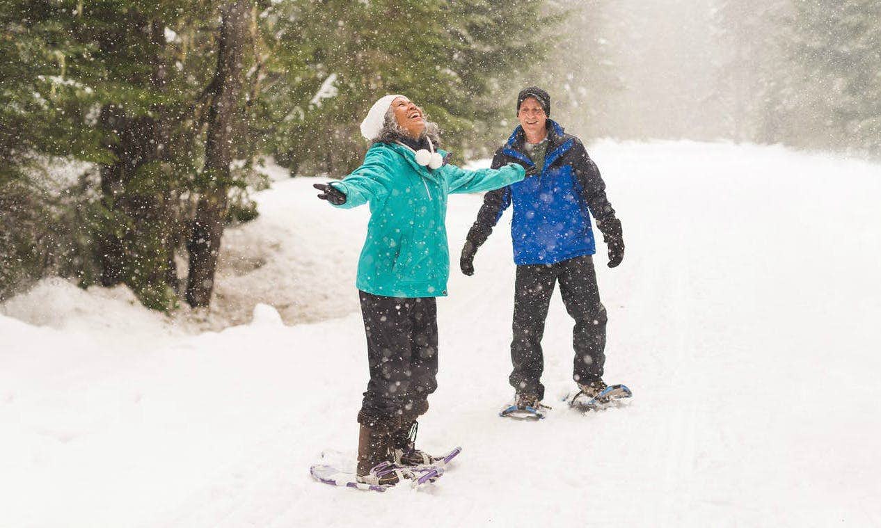 Two people having fun snowshoeing