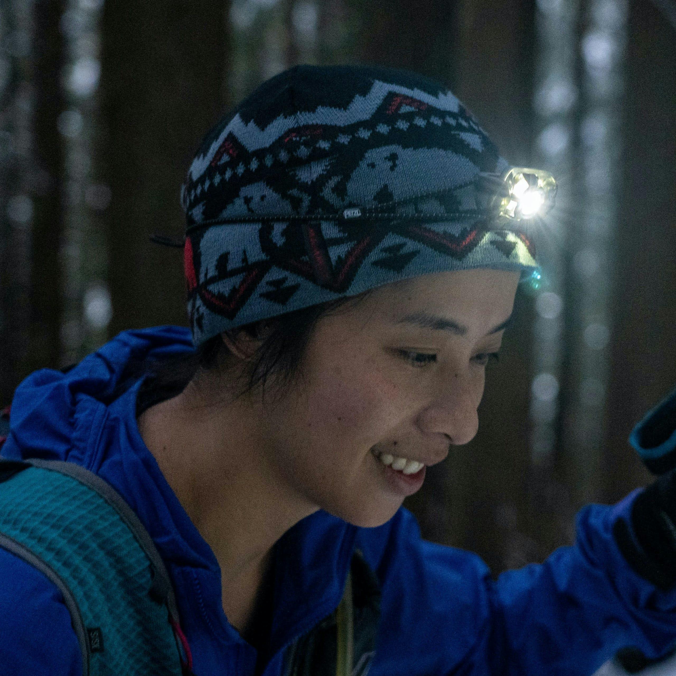 Hiker wearing a toque and a bright headlamp