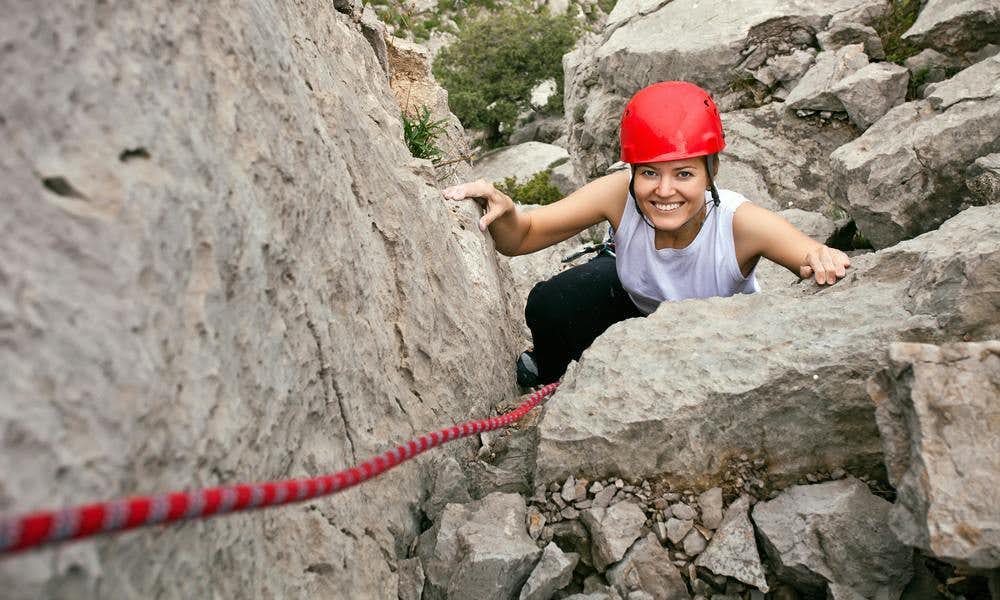 Woman climbing and smiling