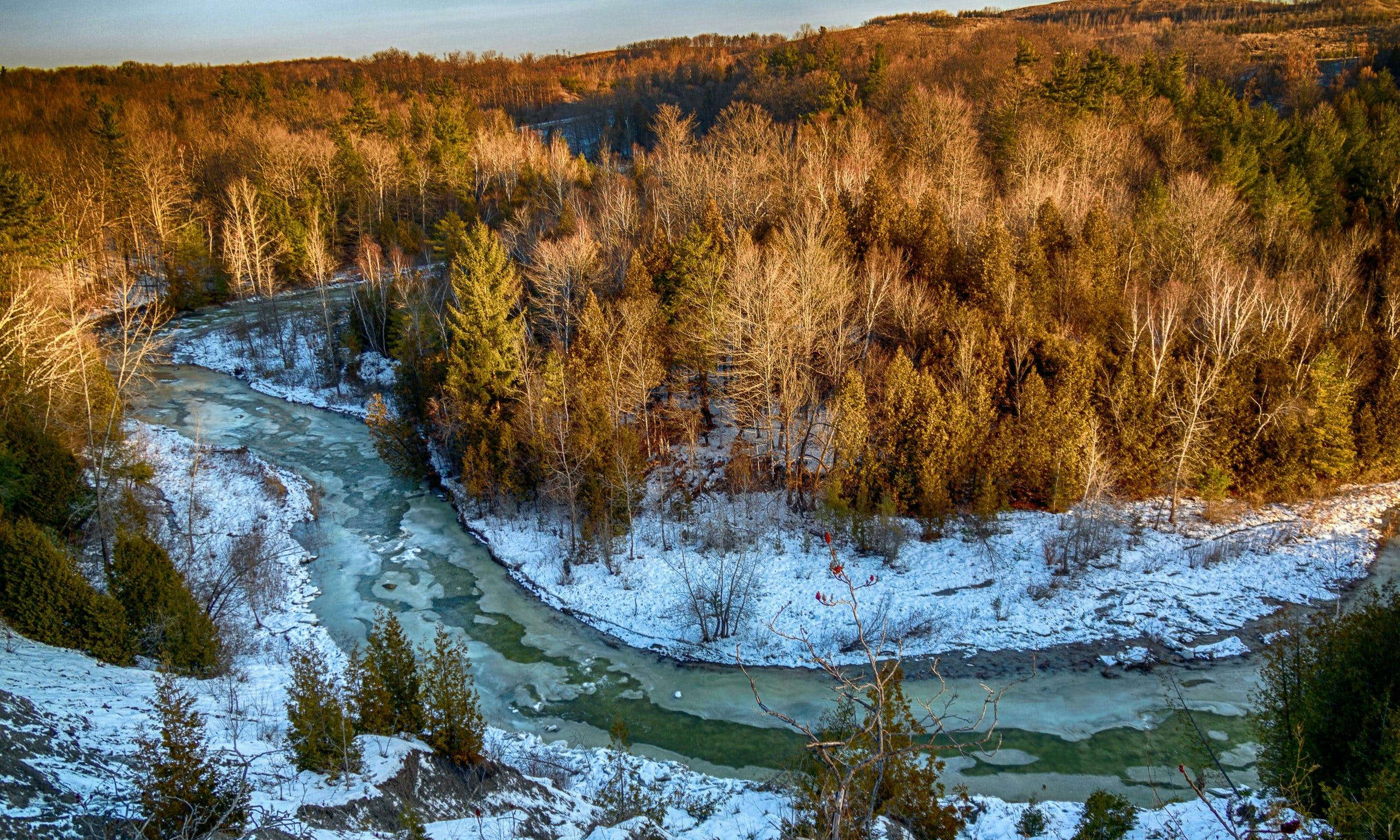 Frosty river and forest view, seen from above