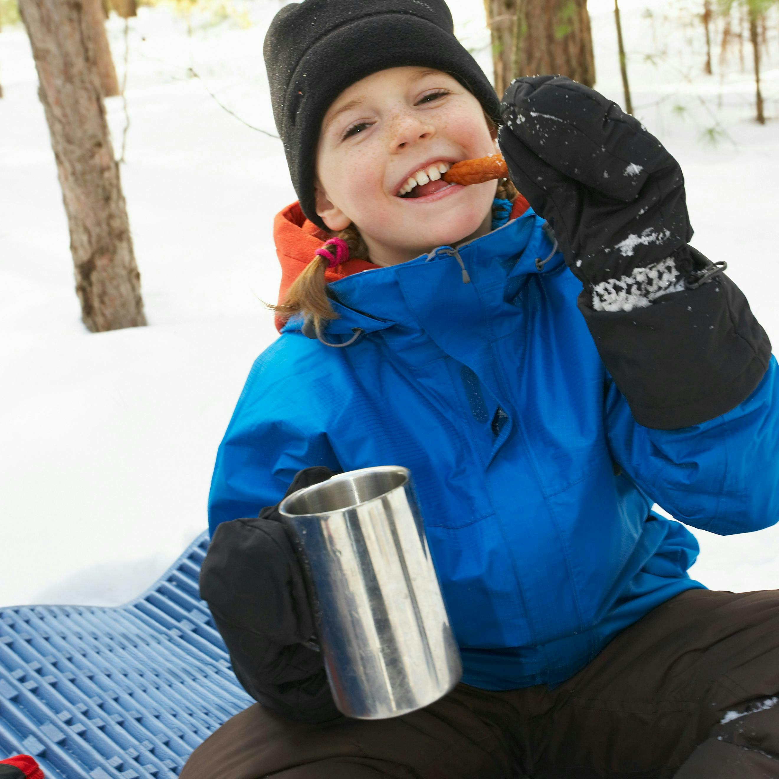 Kid eating snack outside in winter