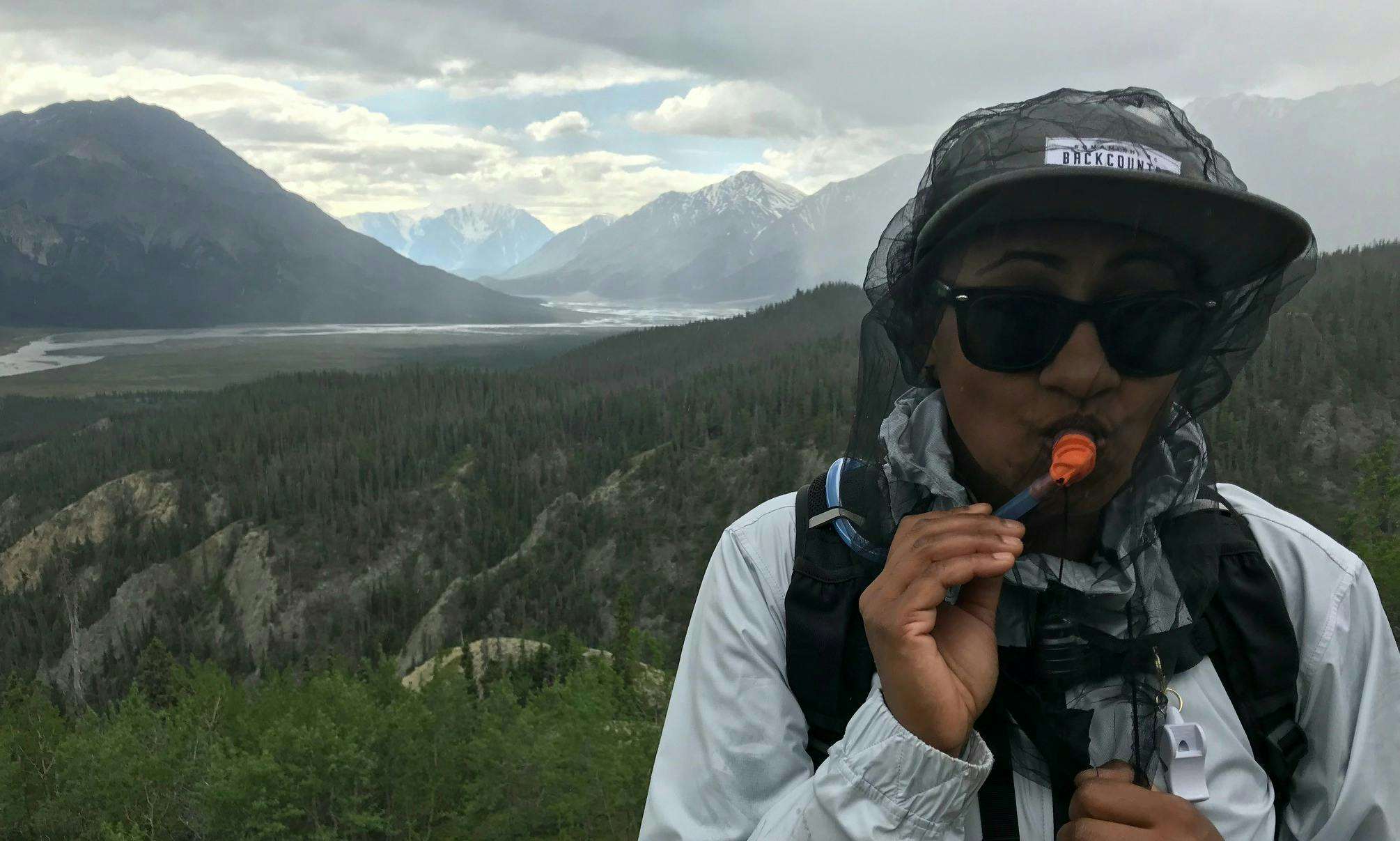 A hydration pack makes it easy to sip water under a bug hat when you’re hiking.