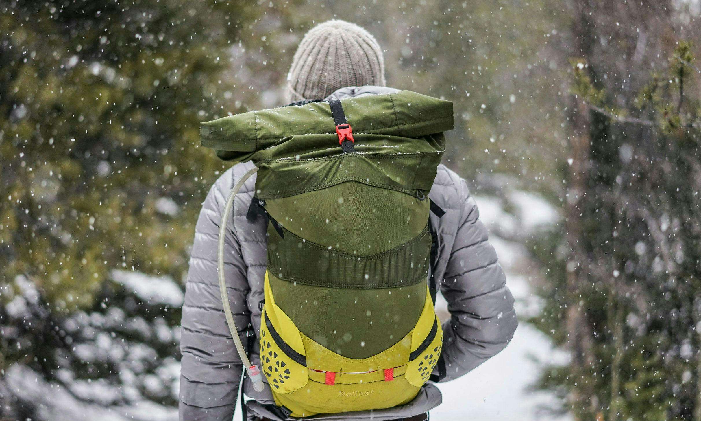 Hiker walking with backpack in snow
