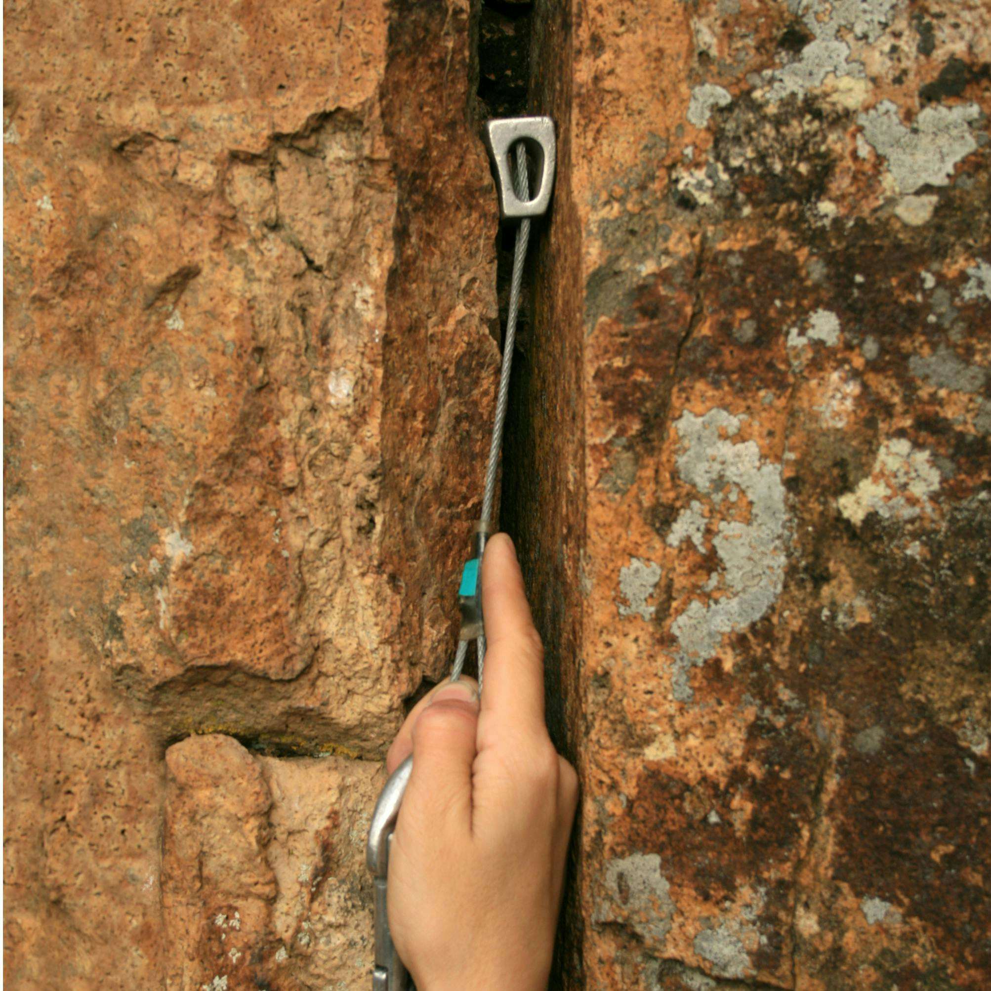 Climber placing a nut into a crack