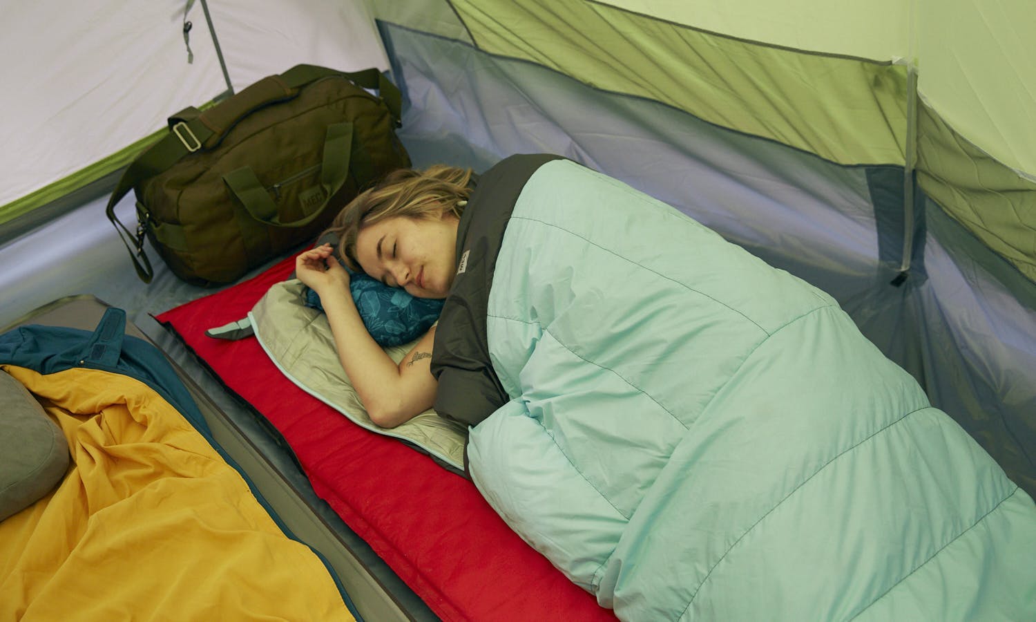 Person sleeping on their side on a camping trip