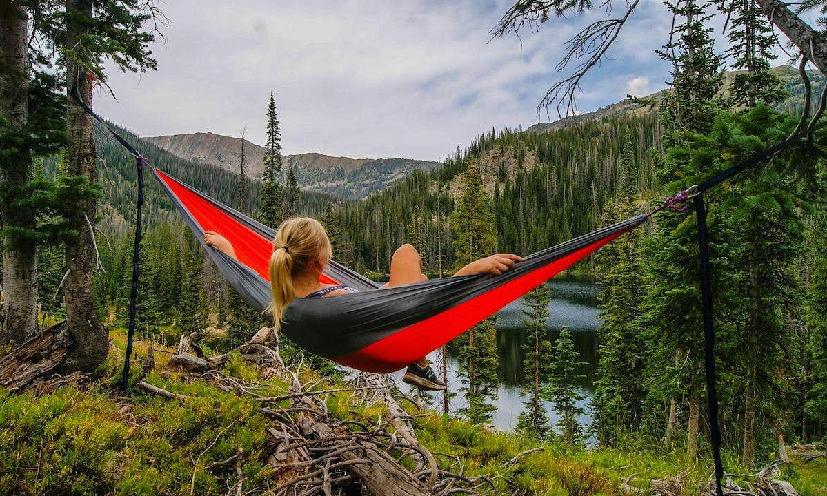 Woman relaxing on a hammock in the forest