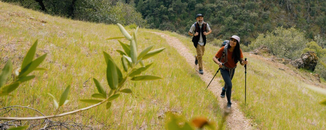 Two people hiking along a path
