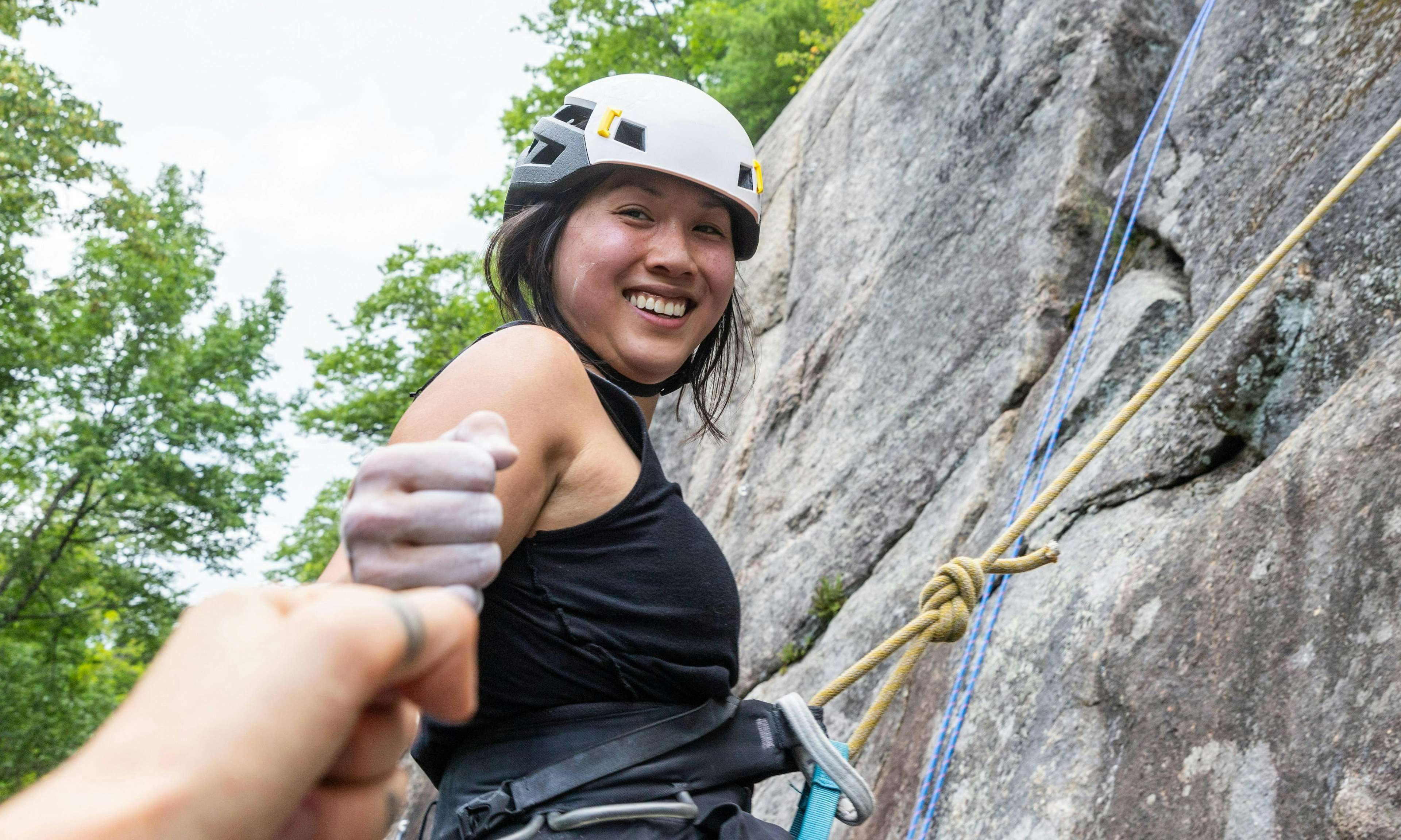 Climber smiling and giving photographer a fist bump