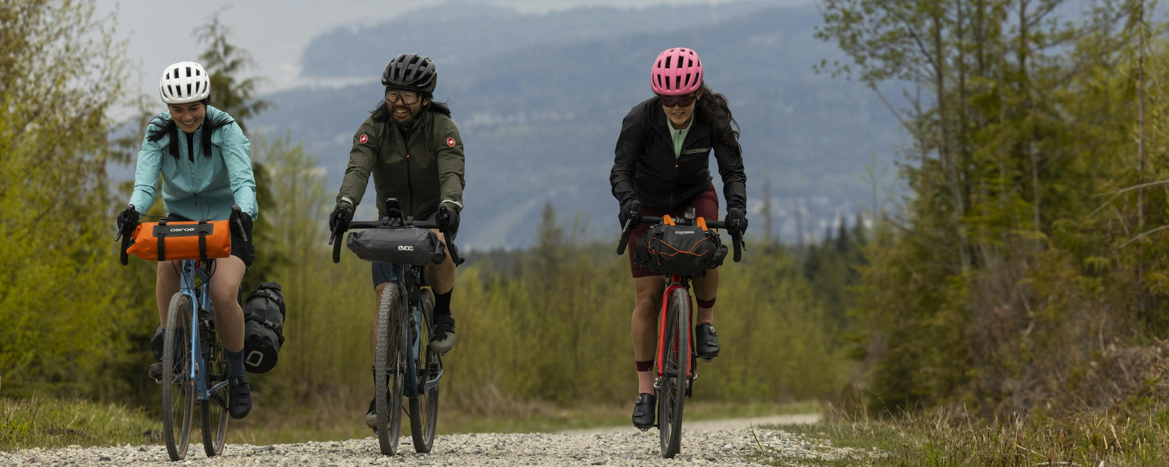 Three riders on a bikepacking trip with loaded bikes on a gravel road